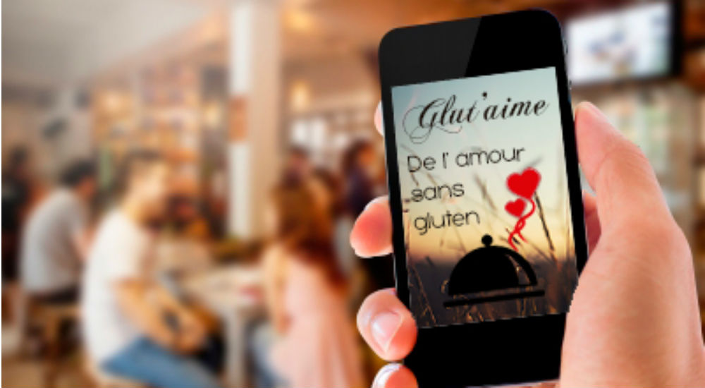 téléphone portable affichant le slogan du site de rencontre glut'aime