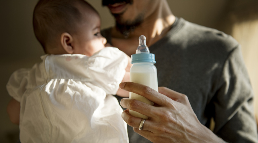 papa donnant le biberon à son bébé